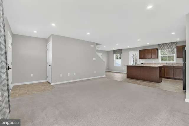 a kitchen with stainless steel appliances granite countertop wooden cabinets a stove top oven a sink and dishwasher