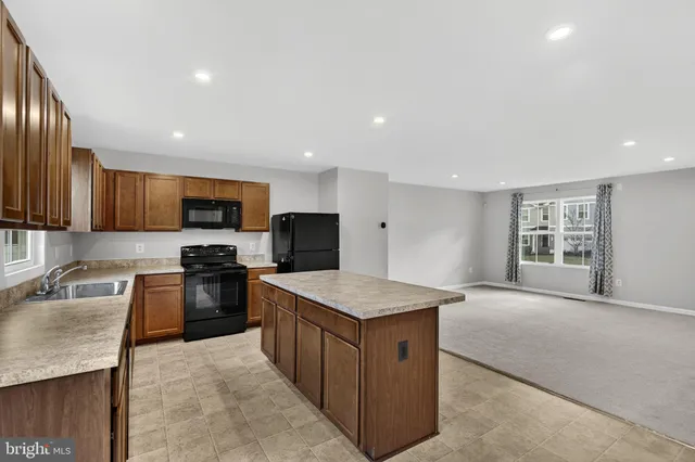 a view of kitchen with microwave oven cabinets and furniture