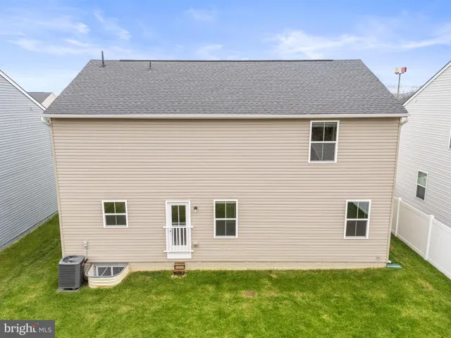 an aerial view of residential houses with outdoor space and swimming pool