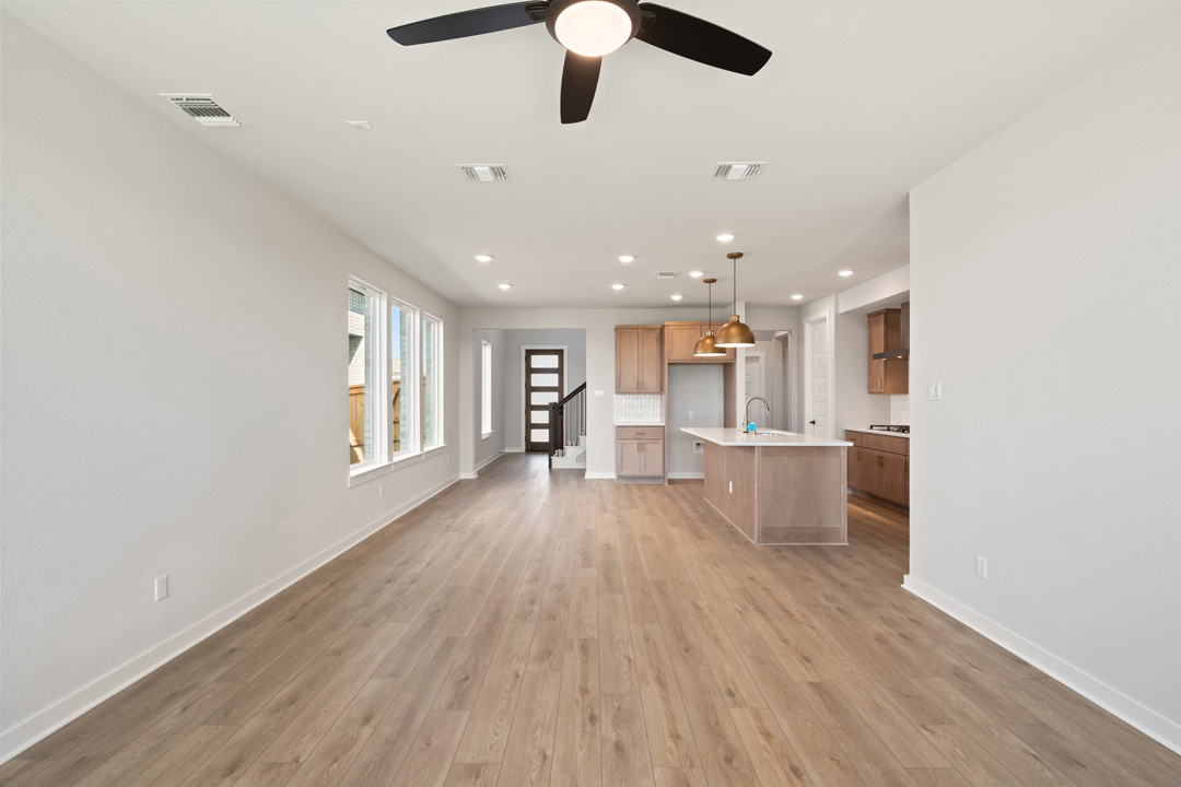 200 Brandywine Road Hutto, TX 78634 - Photo 11 of 39 a view of a living room and kitchen with a large window