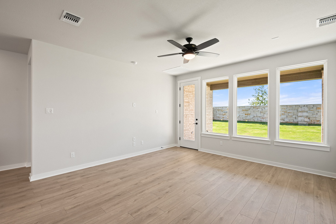 200 Brandywine Road Hutto, TX 78634 - Photo 13 of 39 a view of an empty room with a window and wooden floor