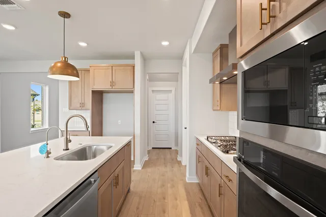 a kitchen with a sink stove and cabinets