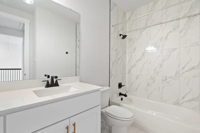 a bathroom with a sink a toilet and a bathtub