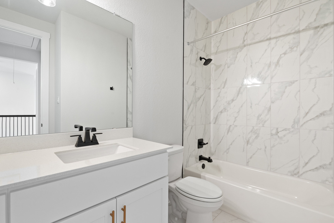 200 Brandywine Road Hutto, TX 78634 - Photo 32 of 39 a bathroom with a sink a toilet and a bathtub