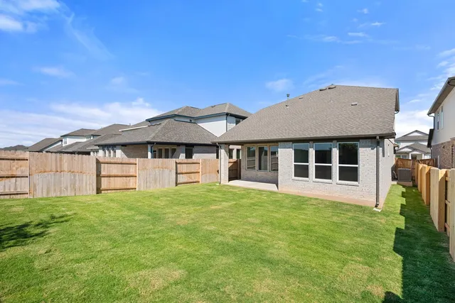 a view of a house with a yard and sitting area
