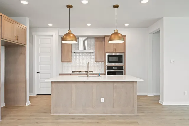 a dining table chairs and a chandelier