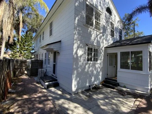 a view of a house with brick walls