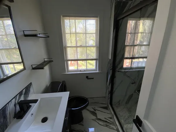 a bathroom with sink and window