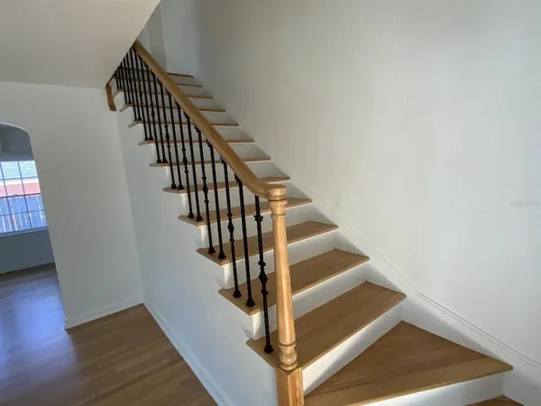 a view of entryway and hall with wooden floor