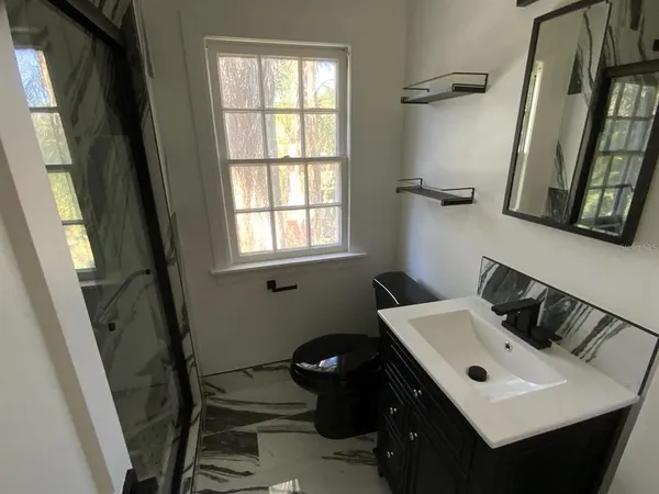 a bathroom with a sink toilet and vanity