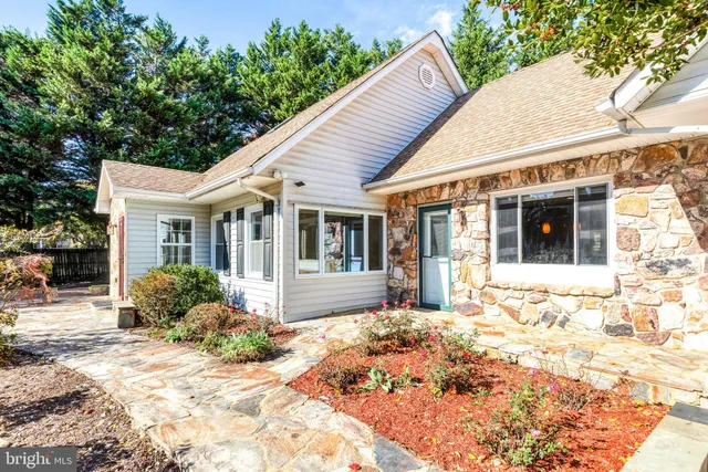 a view of a hallway with wooden floor and entryway