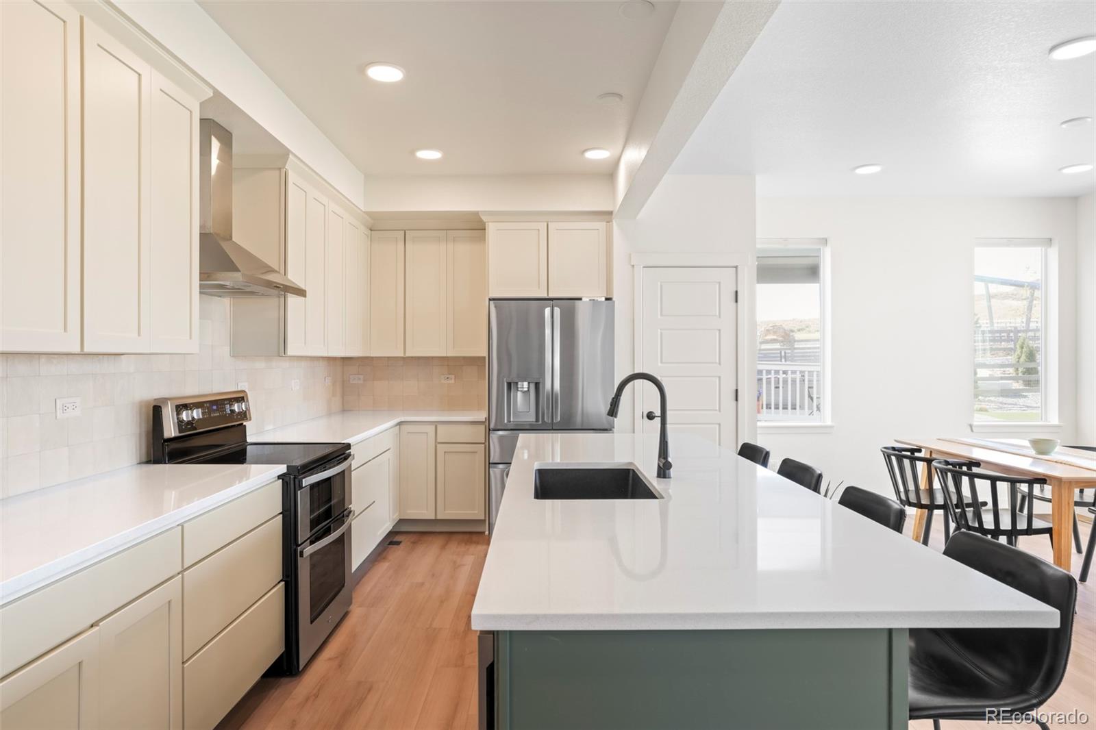 4899 Daven Road Morrison, CO 80465 - Photo 12 of 27 a kitchen with kitchen island a sink appliances cabinets and a counter top space