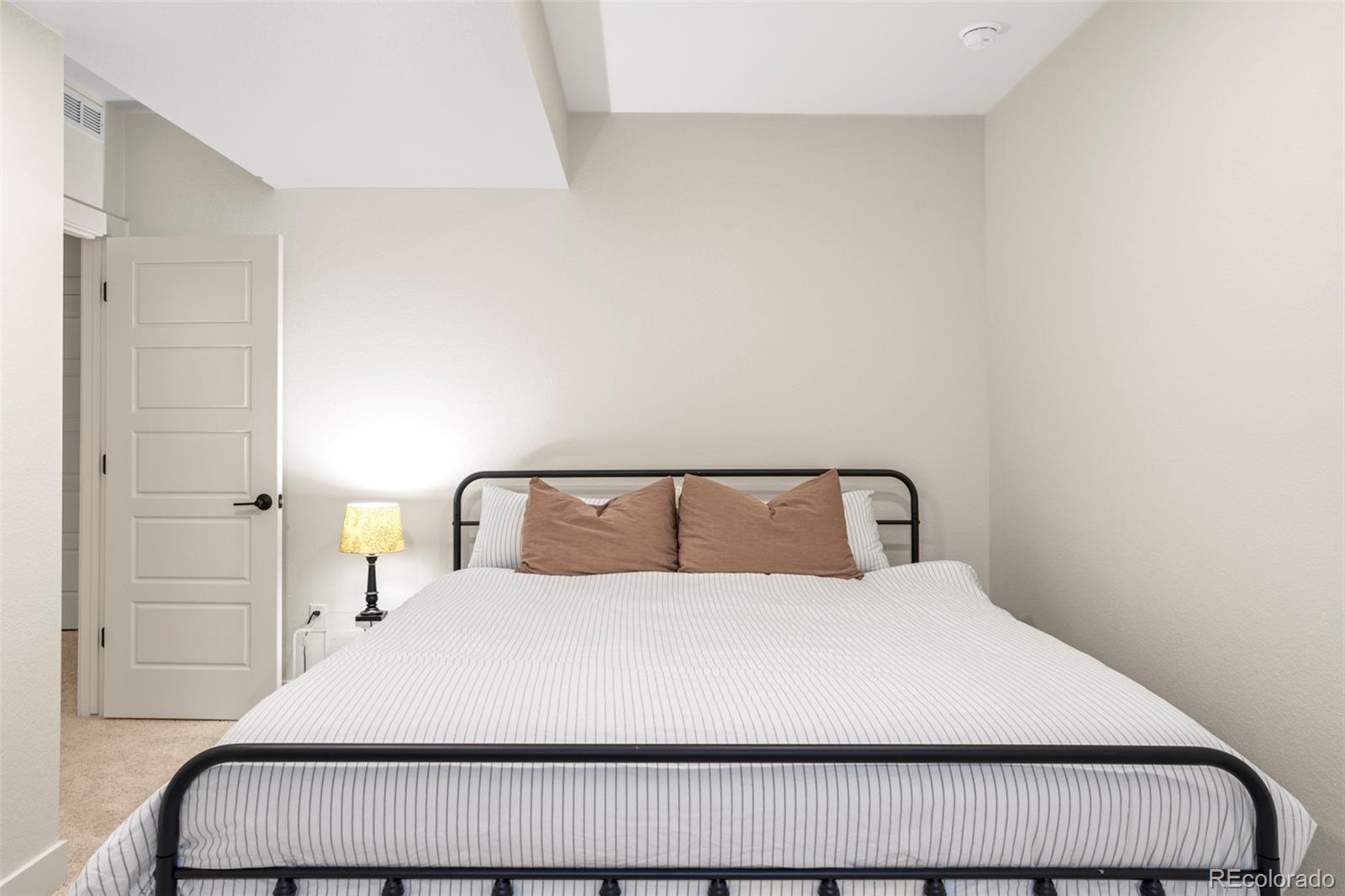 4899 Daven Road Morrison, CO 80465 - Photo 23 of 27 a large bed in a white room