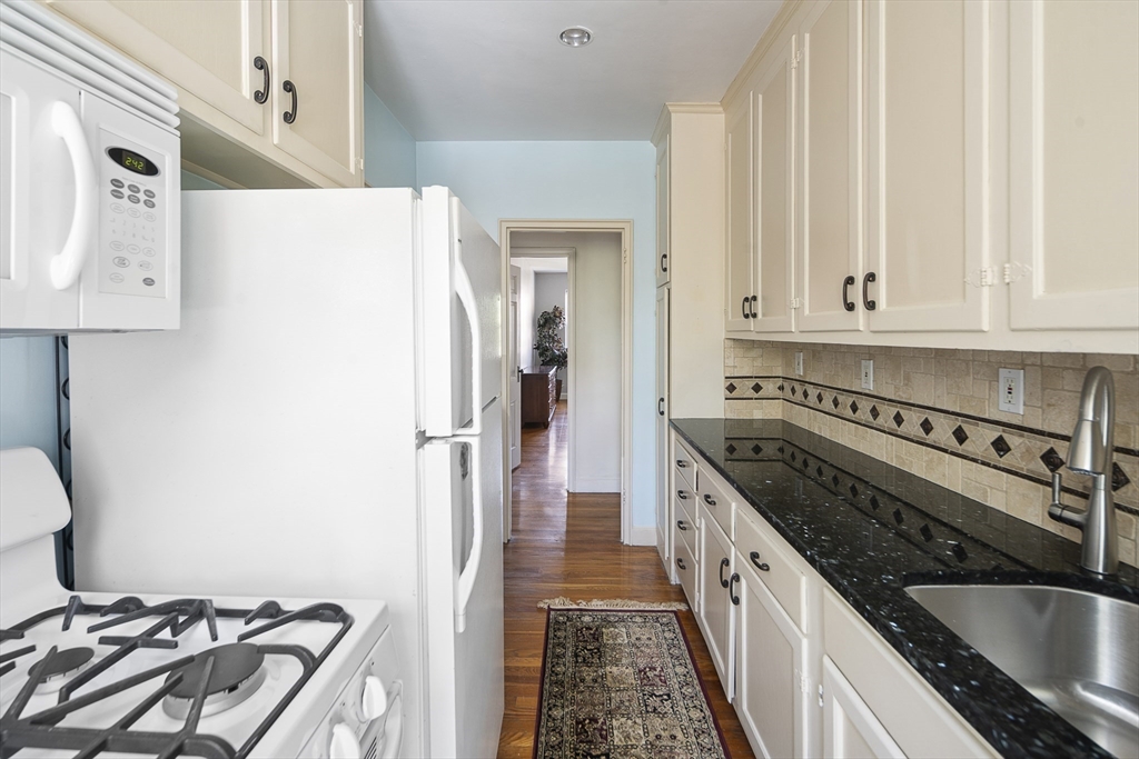 42 Browne Street, Unit 3 Brookline, MA 02446 - Photo 11 of 15 a kitchen with a stove and a refrigerator