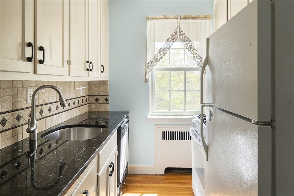42 Browne Street, Unit 3 Brookline, MA 02446 - Photo 10 of 15 a kitchen with granite countertop a sink stainless steel appliances and cabinets