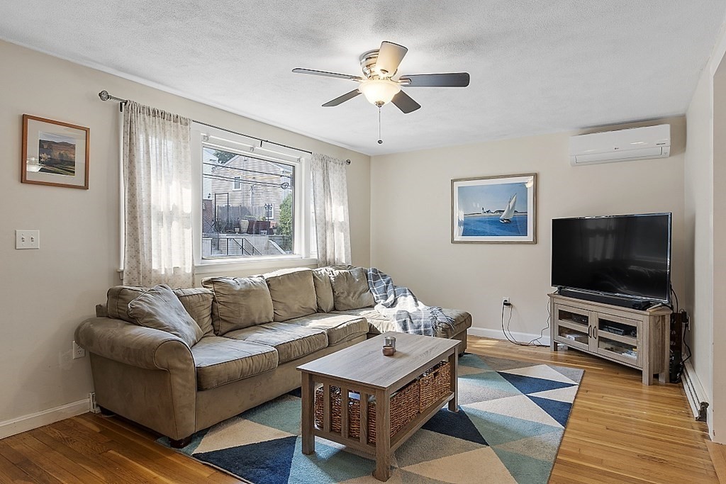 233 College Farm Road Waltham, MA 02451 - Photo 3 of 41 a living room with furniture and a flat screen tv