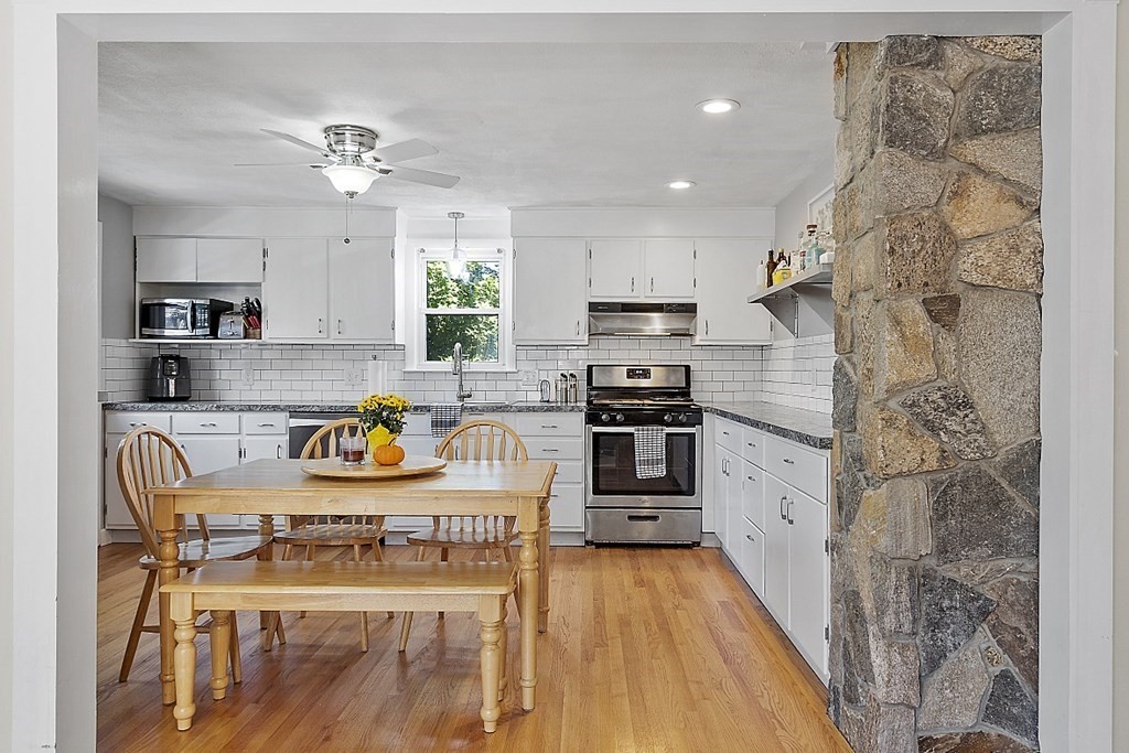 233 College Farm Road Waltham, MA 02451 - Photo 6 of 41 a kitchen with stainless steel appliances granite countertop a sink dishwasher a stove a refrigerator a microwave oven with cabinets and wooden floor