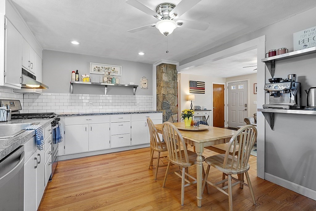 233 College Farm Road Waltham, MA 02451 - Photo 7 of 41 a white kitchen with stainless steel appliances granite countertop a stove oven a sink dishwasher and white cabinets with wooden floor