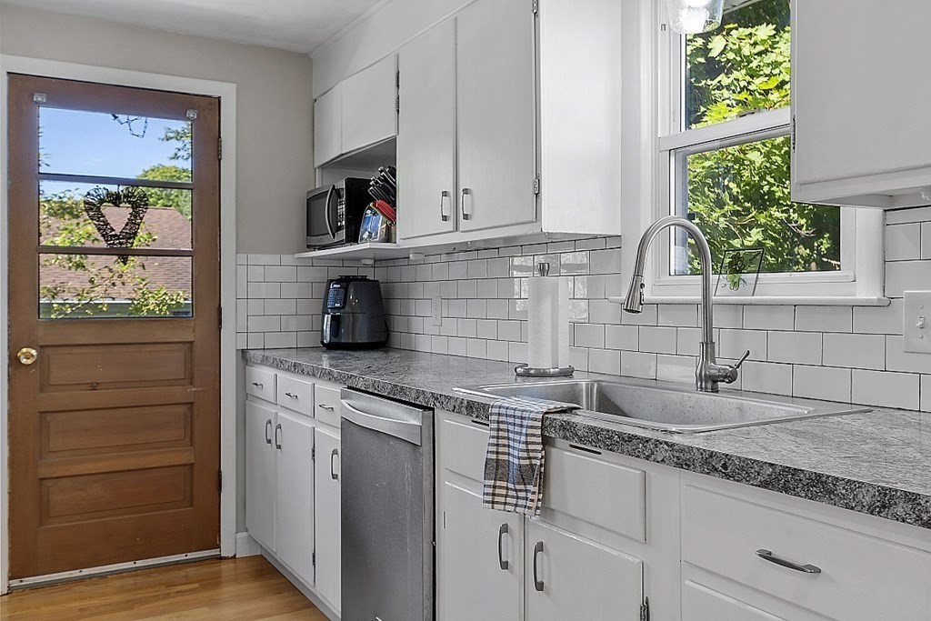 233 College Farm Road Waltham, MA 02451 - Photo 10 of 41 a kitchen with granite countertop a sink and a stove