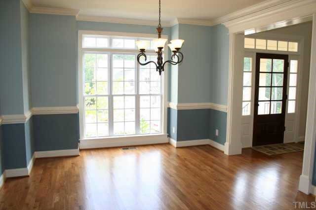 9315 Tabriz Raleigh, NC 27614 - Photo 5 of 10 a view of an empty room with wooden floor and a window