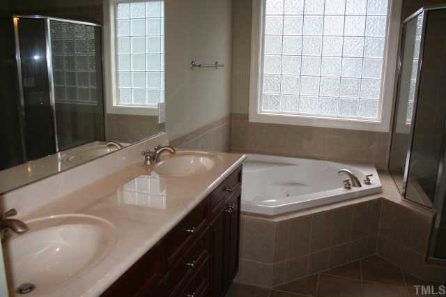 9315 Tabriz Raleigh, NC 27614 - Photo 9 of 10 a bath tub sitting next to a white sink
