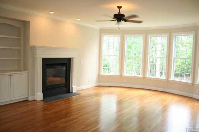9315 Tabriz Raleigh, NC 27614 - Photo 10 of 10 a view of an empty room with a window and wooden floor