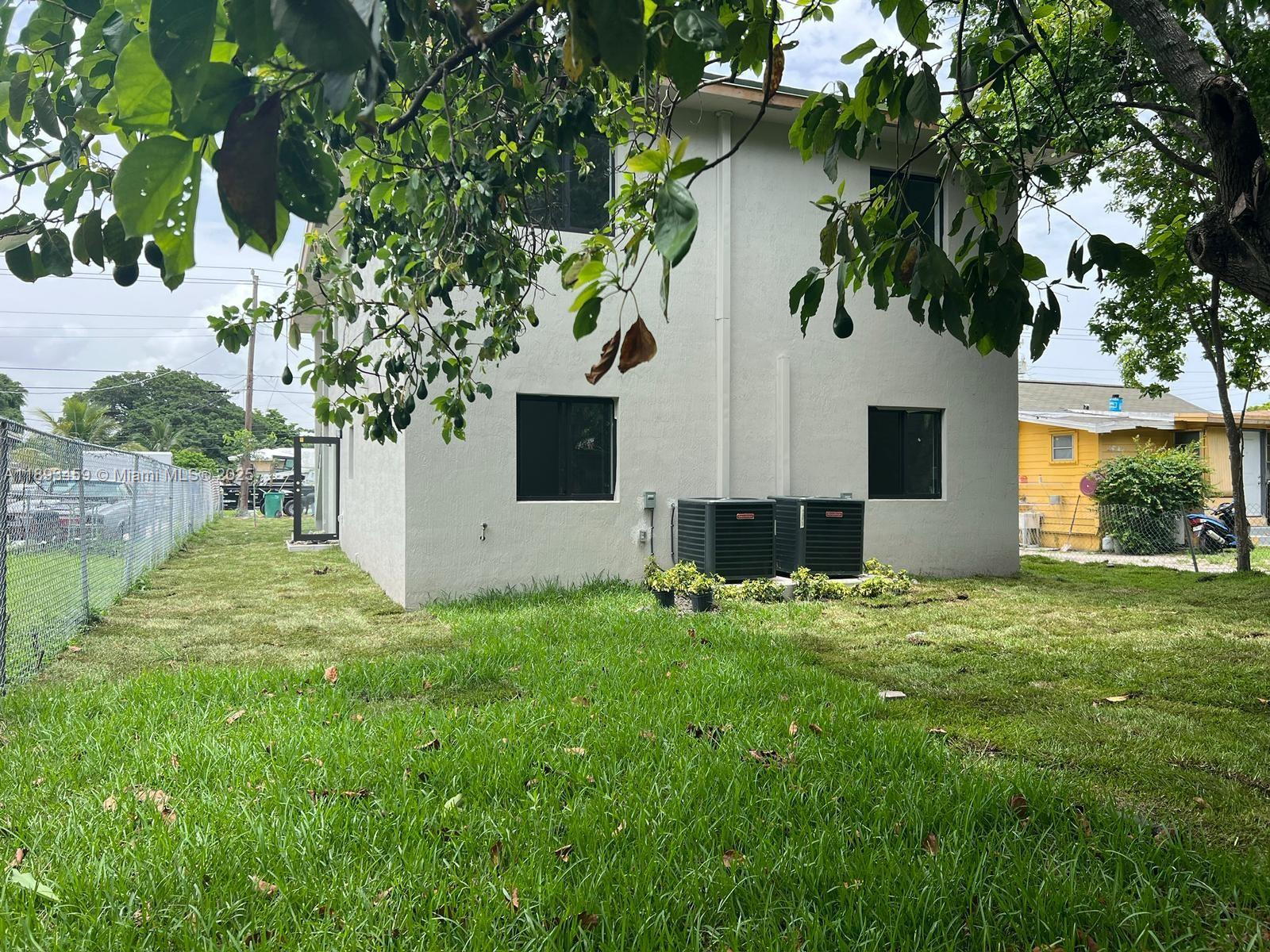 Brownsville Miami, FL 33142 - Photo 4 of 4 a backyard of a house with table and chairs