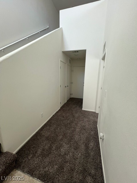 4561 Woolcomber Street Las Vegas, NV 89115 - Photo 16 of 19 Unfurnished room featuring carpet floors and a towering ceiling