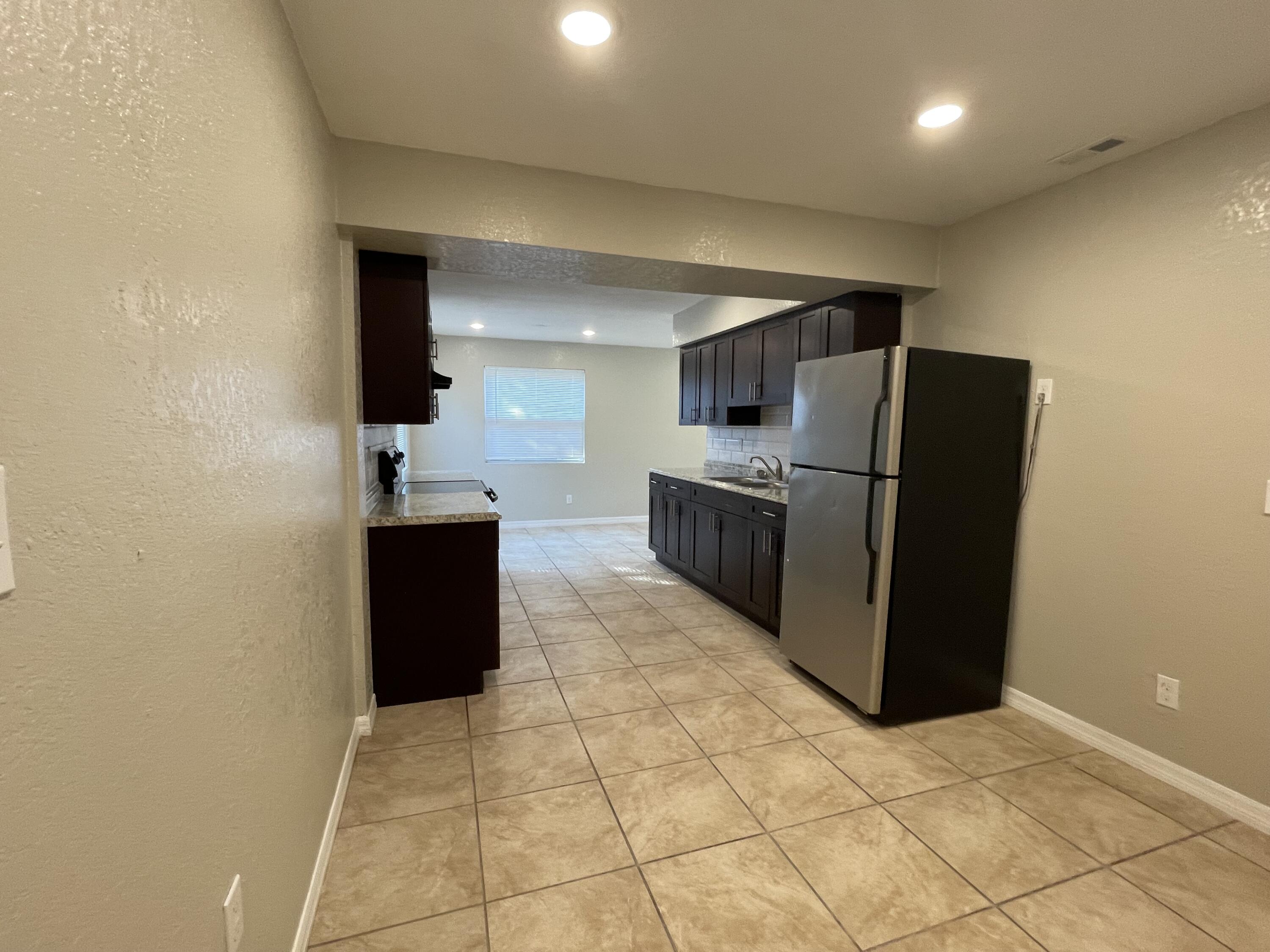 2880 Harson Way Fort Pierce, FL 34946 - Photo 9 of 40 a kitchen with stainless steel appliances a refrigerator and a stove