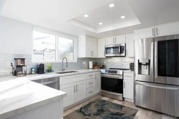 a kitchen with a sink stove and refrigerator