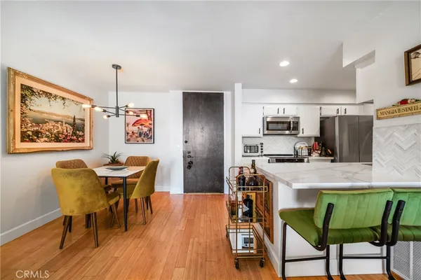 a dining room with furniture and a wooden floor