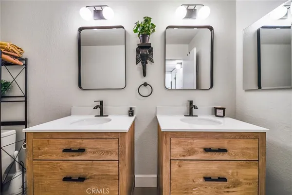 a bathroom with a toilet a sink and shower