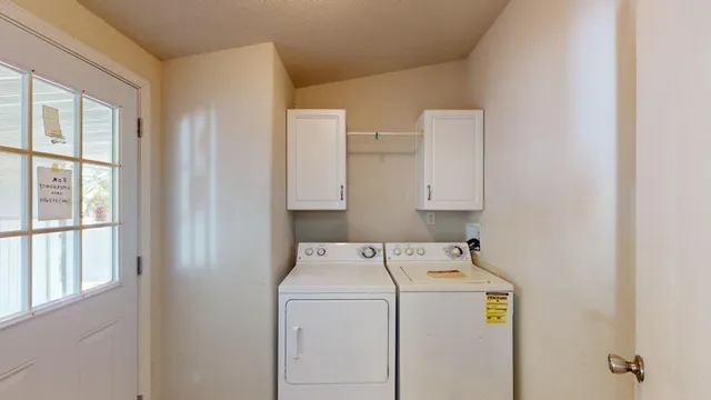 a large kitchen with a sink a window and stainless steel appliances