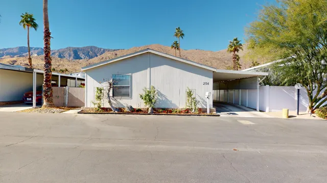 a view of a house with a road and a garage