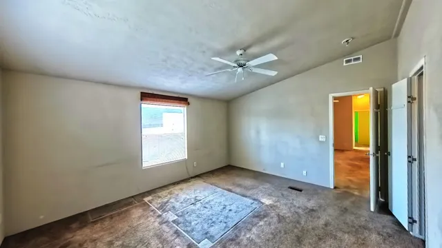 a view of a livingroom with a fireplace and a window