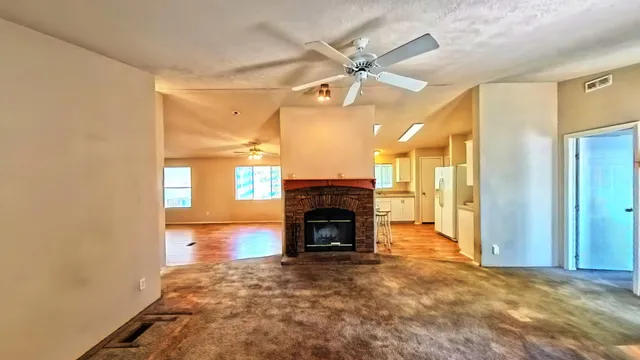 a view of a big room with wooden floor and a bed