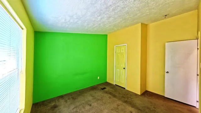 a view of a room with wooden floor and window