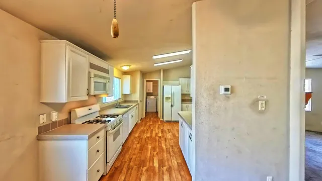 a kitchen with a sink a counter top space and cabinets