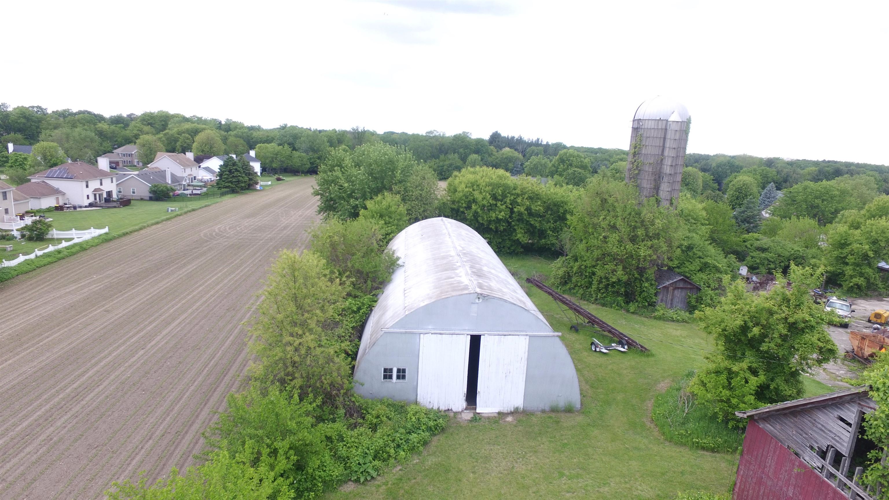 5250 Harvey Road Caledonia, IL 61011 - Photo 7 of 17 an aerial view of a house with a yard and a garden