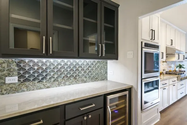 a kitchen with granite countertop a sink and cabinets