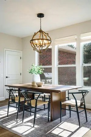 a workspace room with furniture a chandelier and window