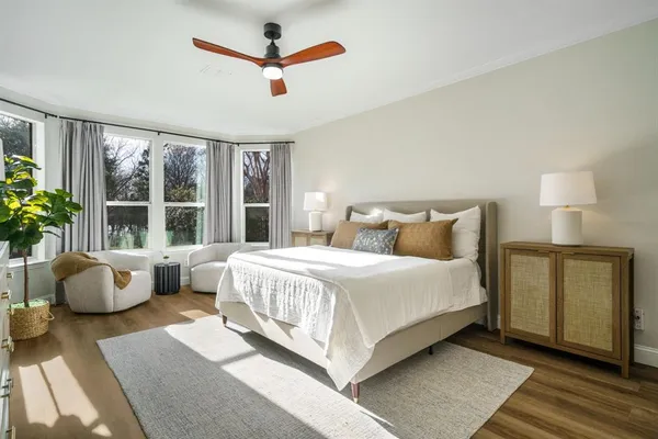 a bedroom with a bed couch and window