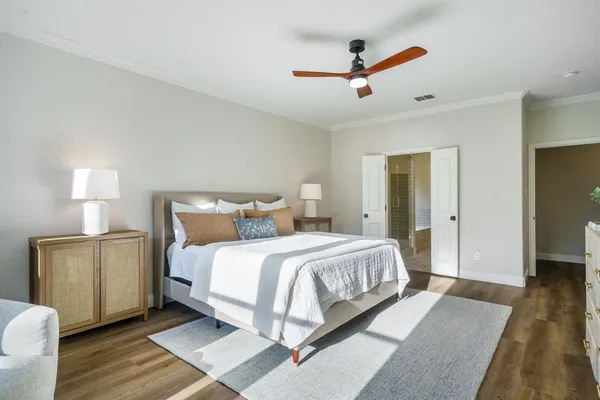 a bedroom with a bed and a ceiling fan
