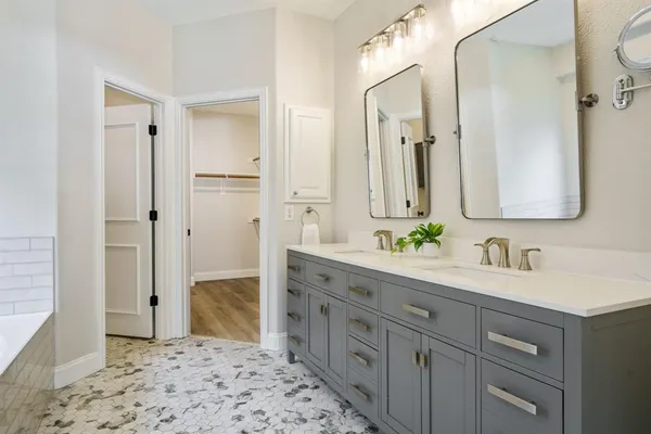 a spacious bathroom with a granite countertop sink mirror and a