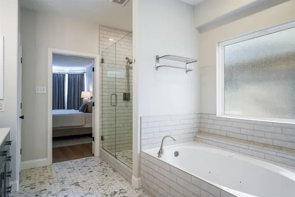 a bathroom with a tub shower and a sink