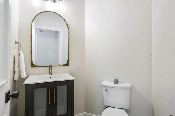a bathroom with a toilet sink and mirror