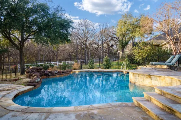 a view of a swimming pool with a patio
