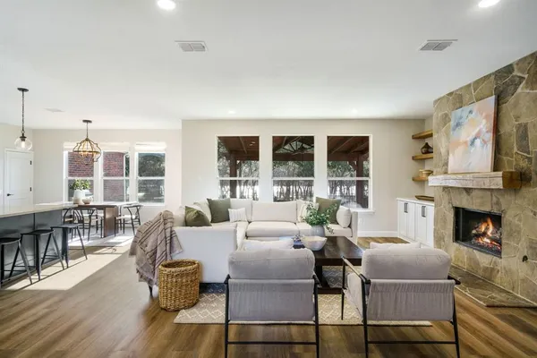 a living room with furniture fireplace and window