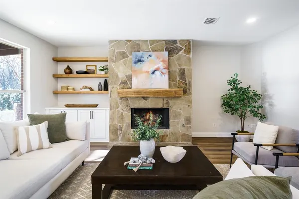a living room with furniture and a fireplace