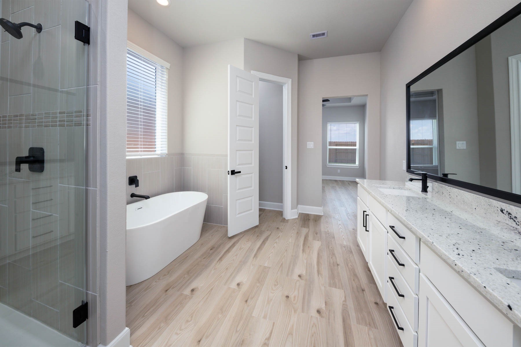 1907 June Lk Lane Iowa Colony, TX 77583 - Photo 5 of 11 a bathroom with a granite countertop tub sink shower and mirror
